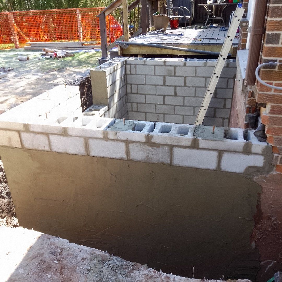 Professional parging application on foundation wall